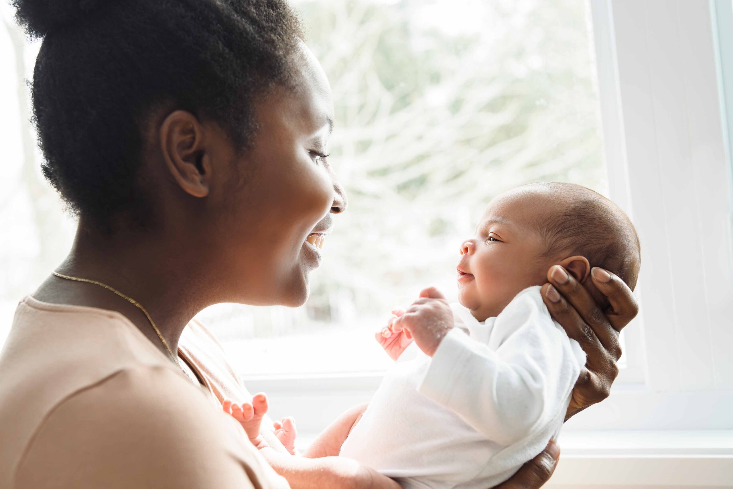 Ritratto di una mamma che tiene in braccio il suo bambino appena nato che può beneficiare del Bonus nuovi nati 2025
